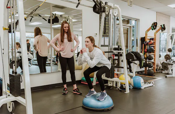 Christine training client on a BOSU ball.