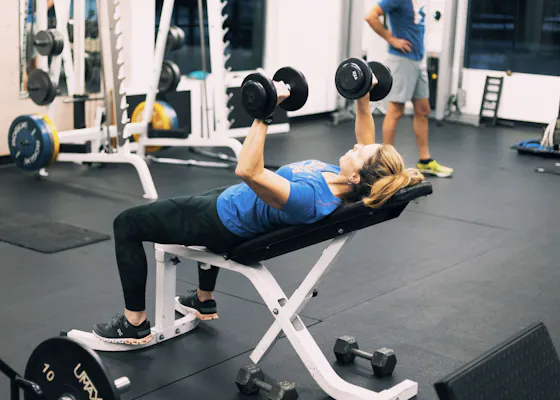 Client doing a dumbbell incline bench press.
