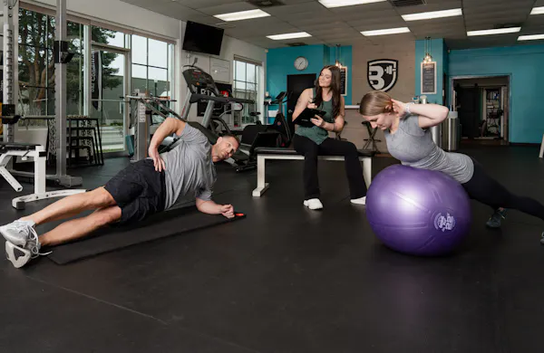 Taylor training clients on core exercises.
