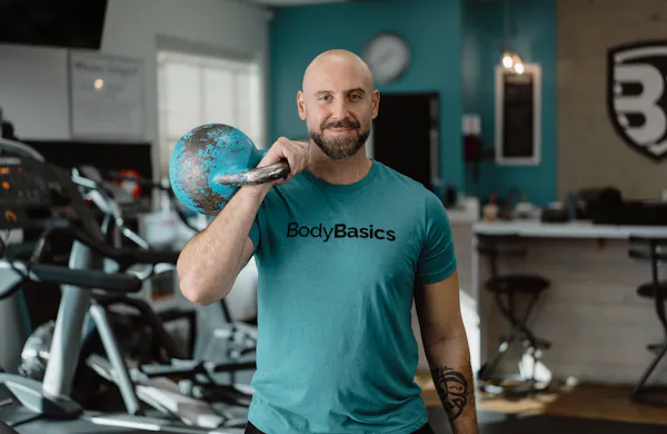Trainer holding a kettlebell.